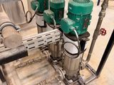 a machine that has a bunch of green pumps on top of it