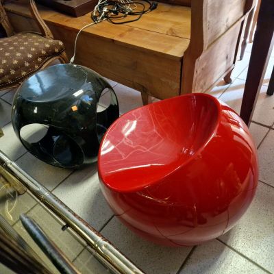 a red bowl sitting on the floor next to a green bowl