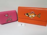 orange and pink purses with a picture of a fish on the front