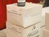 boxes of wine are stacked on top of each other on a table