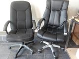 two office chairs sitting next to each other on a tiled floor