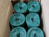 a cardboard box with a bunch of rolls of blue plastic