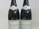 two bottles of wine sitting next to each other on a table