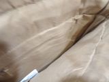 a cat that is laying on a couch with a tag on it