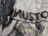 a lot of clothing wrapped in plastic bags on the floor