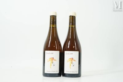two bottles of wine sitting next to each other on a white surface