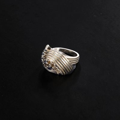 a close up of a silver ring on a black surface