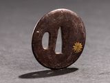 a small coin with a flower on it sitting on a table