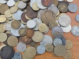 a pile of coins sitting on a wooden table