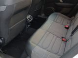 the back seats of a white car with a black seat belt