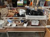 de nombreux plats et bols disposés dans un panier en fil de fer posé sur une table