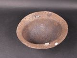 a brown bowl sitting on top of a black table