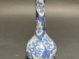 a blue and white vase sitting on top of a table