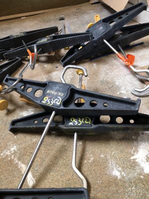 a lot of clamps and other tools on the floor
