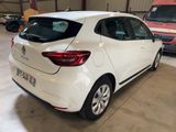 the rear end of a white car parked in a garage