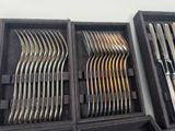 many forks and spoons in a case on the table