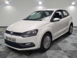 the white volkswagen polo is parked in a room with a checkered floor