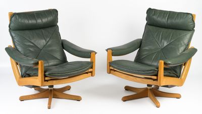 pair of green leather swive chairs with wooden legs and arms
