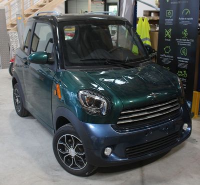 une petite voiture verte garée dans un garage