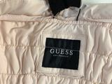 a white quilted jacket with a black label on it