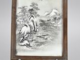 a framed picture of a bird sitting on a rock near a body of water
