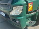 a green truck that is parked in the parking lot