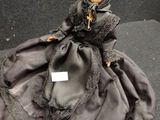 a doll that is sitting on a black table