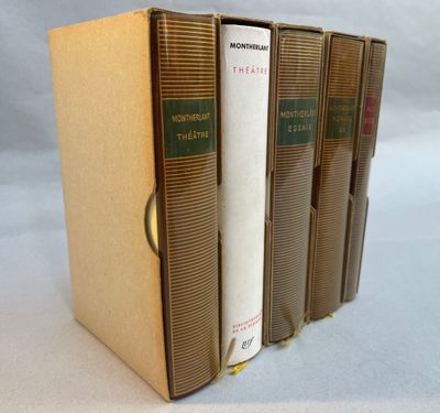 three books are stacked on top of each other on a white surface