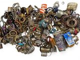 a pile of assorted jewelry on a white surface