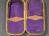 purple cloth in a yellow case on a gray surface