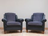 pair of mid - century style armchairs in blue velvet upholstered with walnut legs