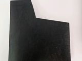 a piece of black paper sitting on top of a white table