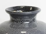 a black and white vase sitting on a table