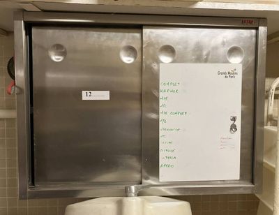 a white board on the wall of a public restroom