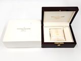 a box with a watch inside of it on a white surface