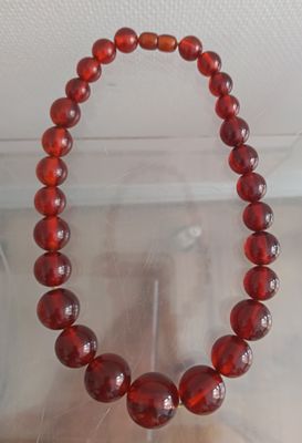 red glass beaded bracelet with silver clasp