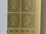 an old stamp with a picture of a man on it on a piece of paper