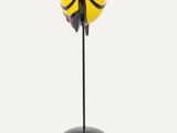 a close up of a yellow and black object on a black stand
