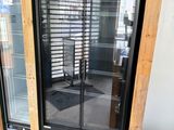a glass door that is open on the outside of a building