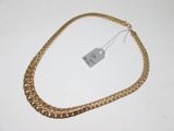 a close up of a gold chain with a price tag on it