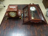 two clocks that are sitting on a wooden table
