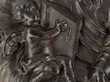 a statue of a man holding a book and a child
