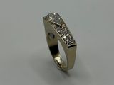 a close up of a diamond ring on a white surface