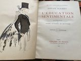 an open book with a drawing of a woman in a dress and top hat