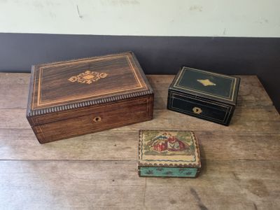 three boxes sitting on a wooden table next to each other