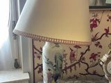 a table with a lamp and a clock on it