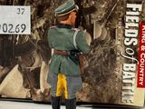 figurine of a man in a military uniform standing in front of a box