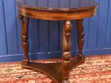 a small table with a wooden top on a rug