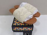 pair of women ' s slippers on top of a box on a table