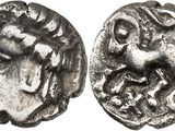 a close up of a coin with a face on it